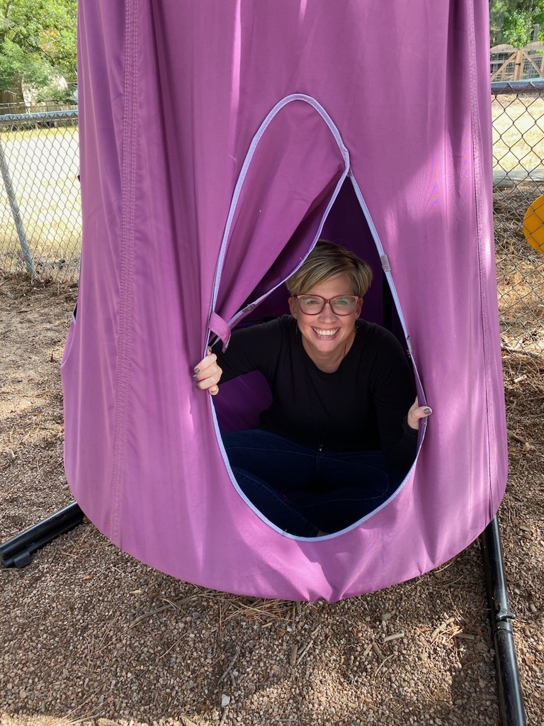 Ms. Molly showing the preschoolers our new outdoor swing!