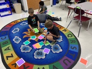 Students figuring out how to code an Indi robot in Mrs. Parker and Mrs. Wyman's after school class.   They determined which color would make the Indi stop, go, turn, spin, and more.  They then programmed the Indi to go around their partner!